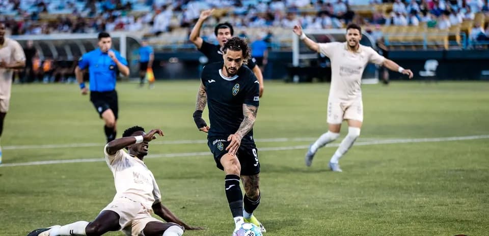 Un jugador driblando durante el partido de fútbol