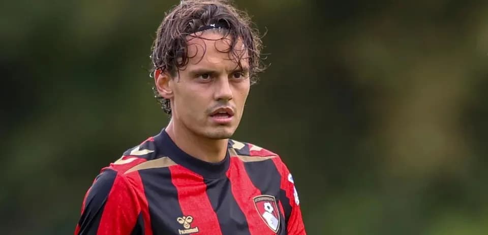 Jugador con camiseta roja y negra en el campo