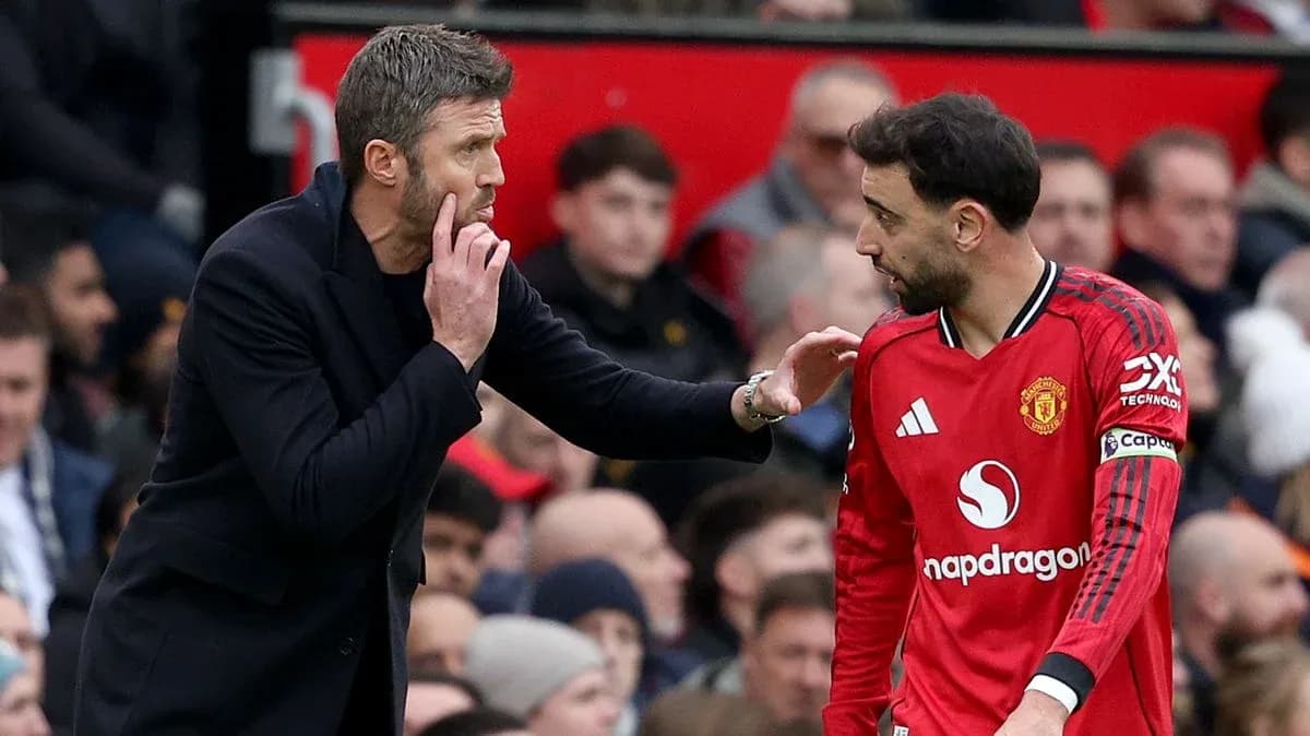 Entrenador dando instrucciones a jugador de Manchester United
