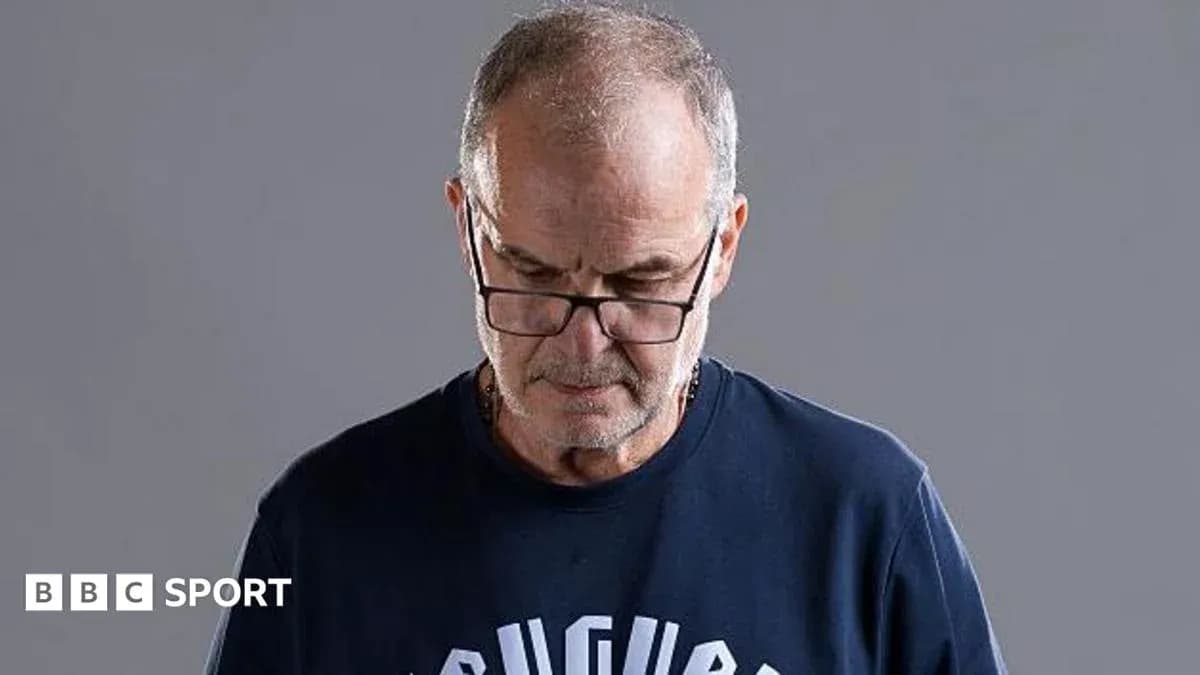 Hombre con gafas mirando hacia abajo en fondo gris