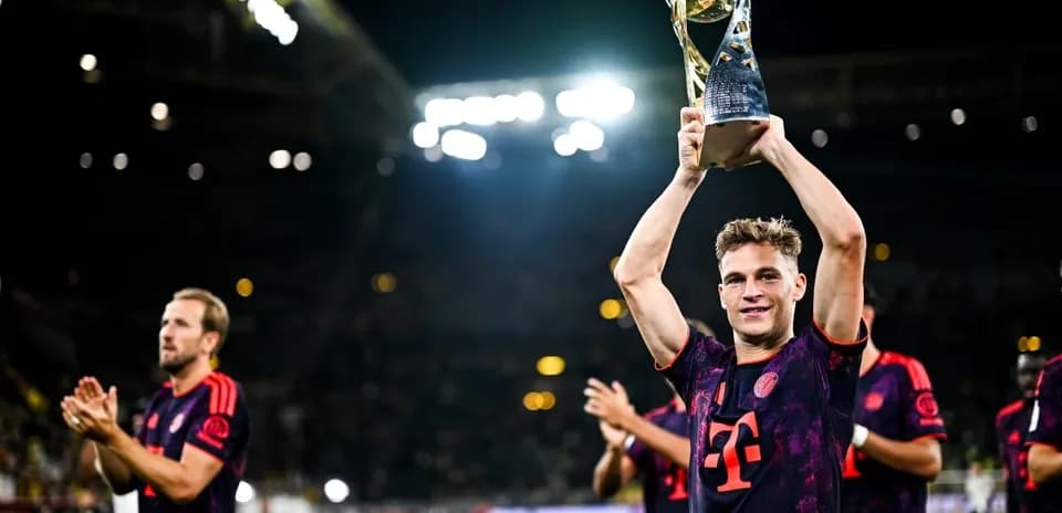 Jugador levantando trofeo con su equipo celebrando