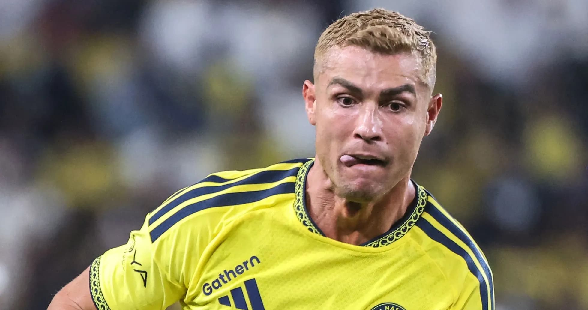 Jugador corriendo con balón en uniforme amarillo