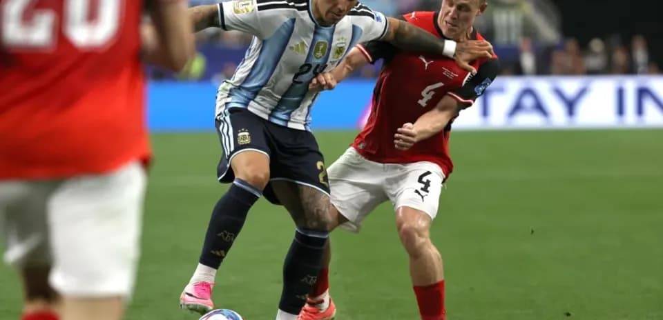 Jugador argentino luchando por el balón contra oponente