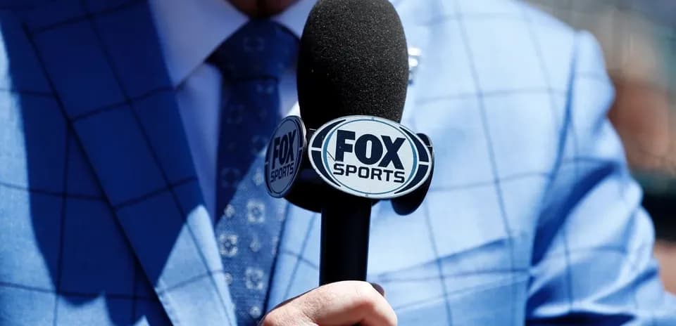 Mic with FOX Sports logo held by person