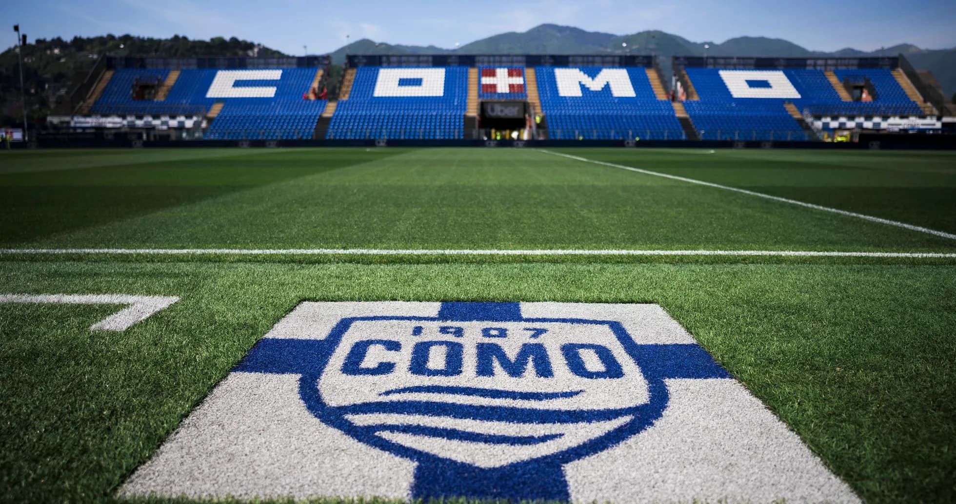 Campo de fútbol con logo de Como 1907 visible