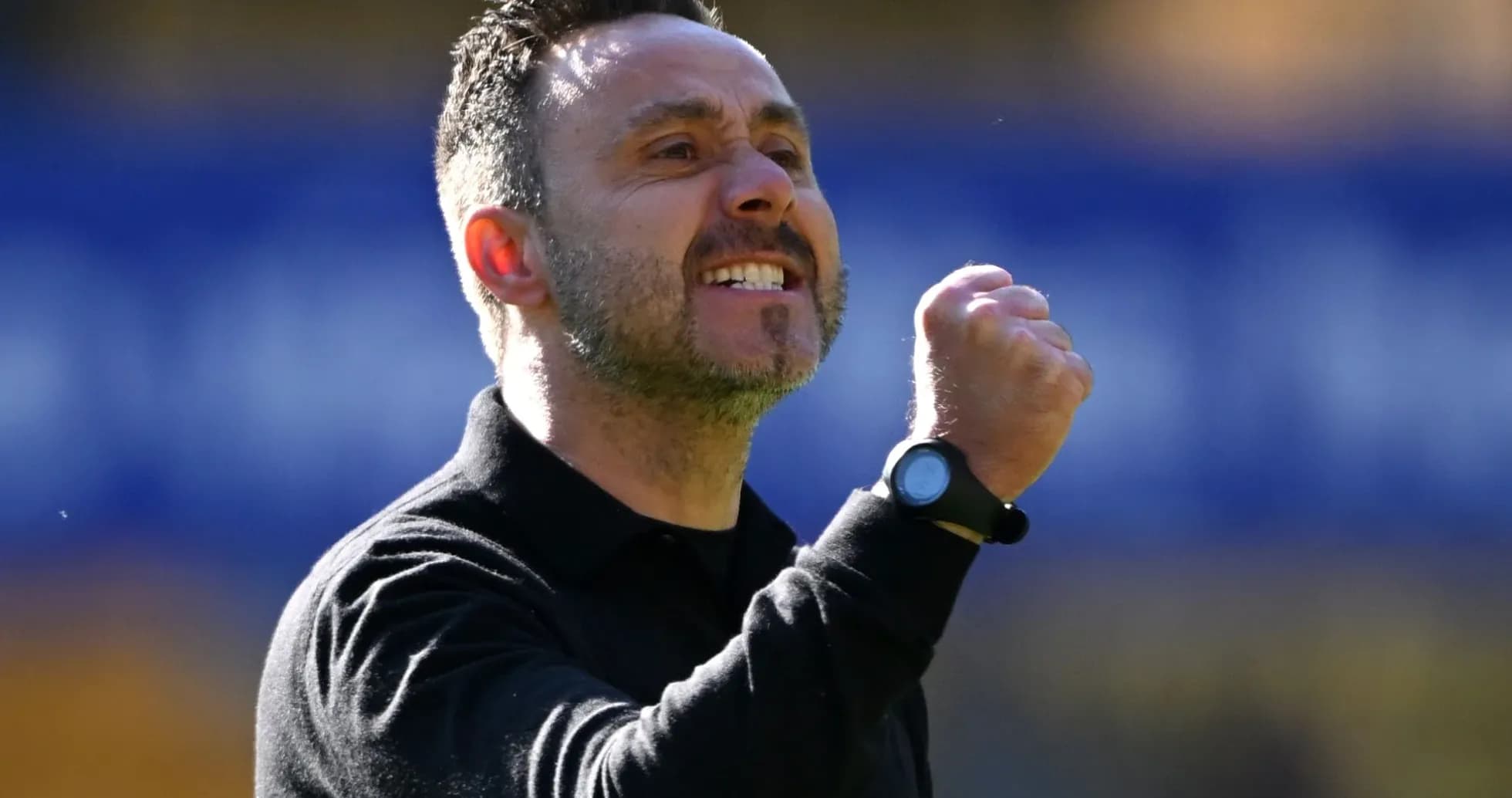 Entrenador celebrando con un puño en alto
