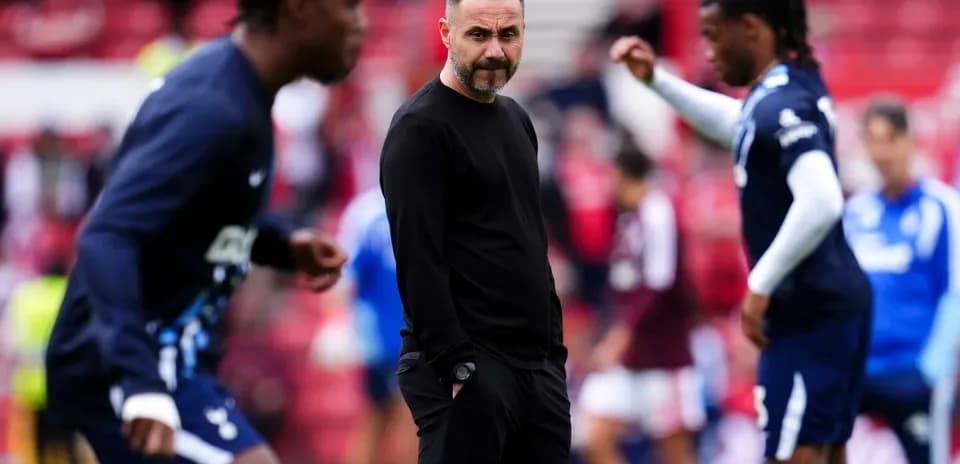 Entrenador observando jugadores en calentamiento previo al partido