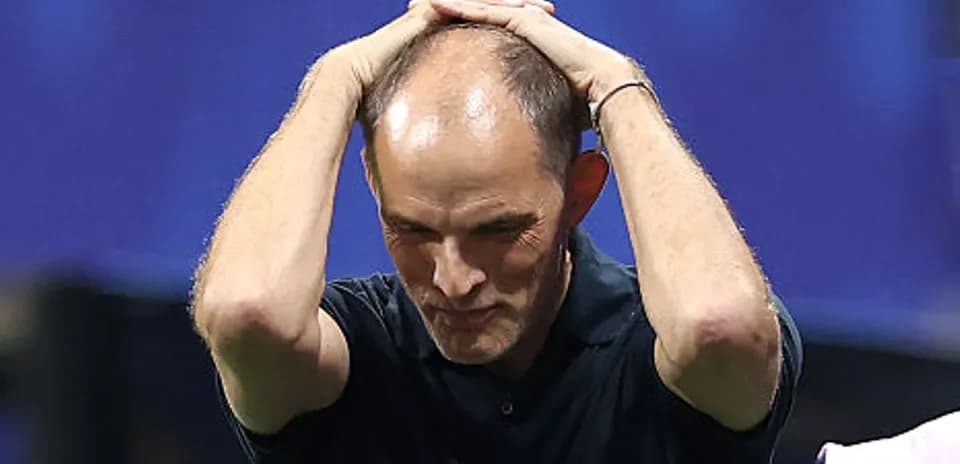 Entrenador sosteniendo la cabeza durante el partido