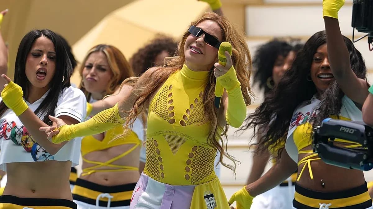 Artista en actuación con bailarinas en escena
