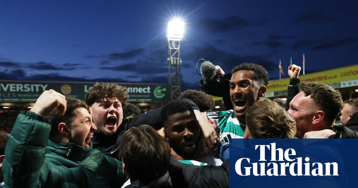 Agroup of fans celebrating a victory at the stadium