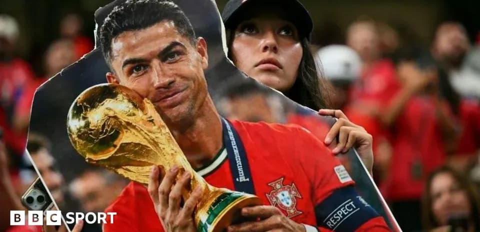 A fan holding a cutout of Cristiano Ronaldo