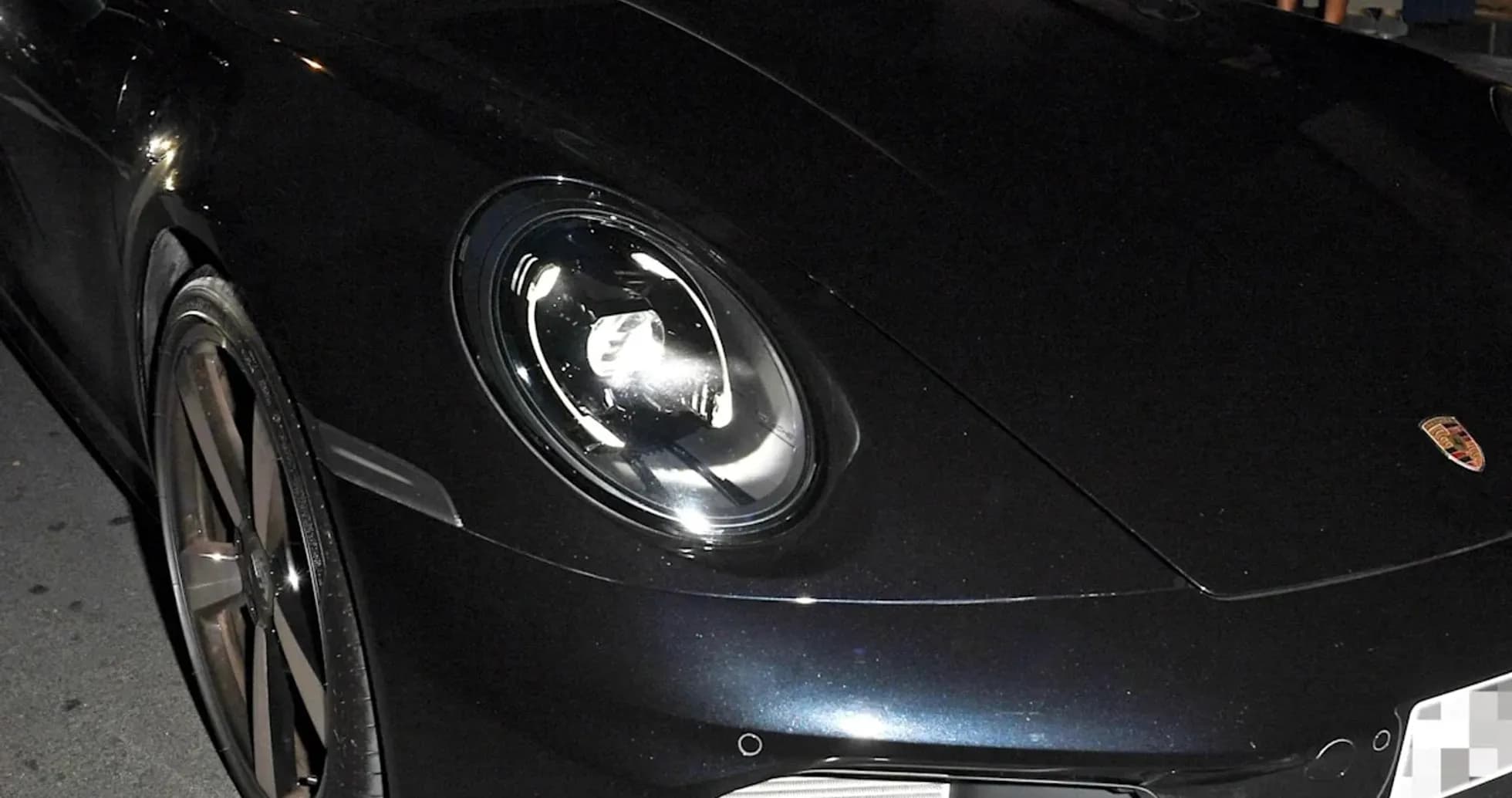 Dos hombres en un coche deportivo Porsche en la noche
