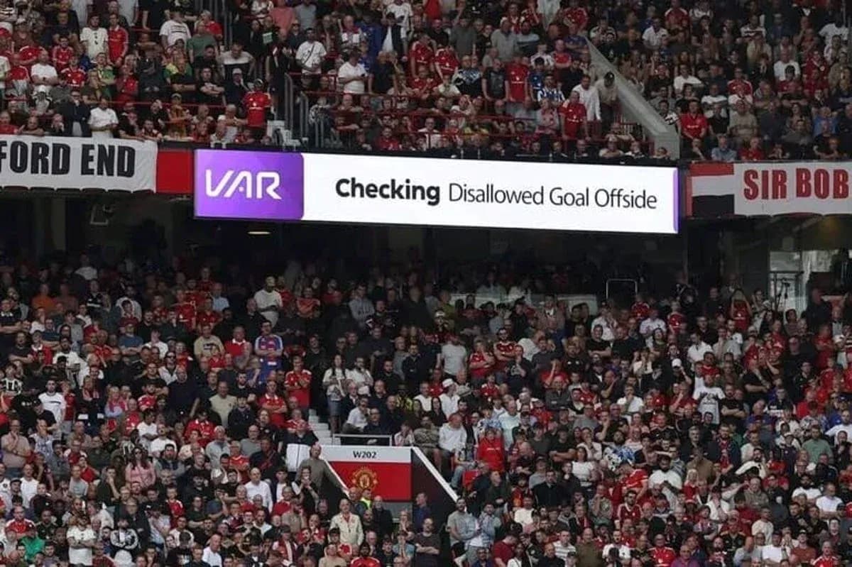 A crowd watching VAR decision for disallowed goal