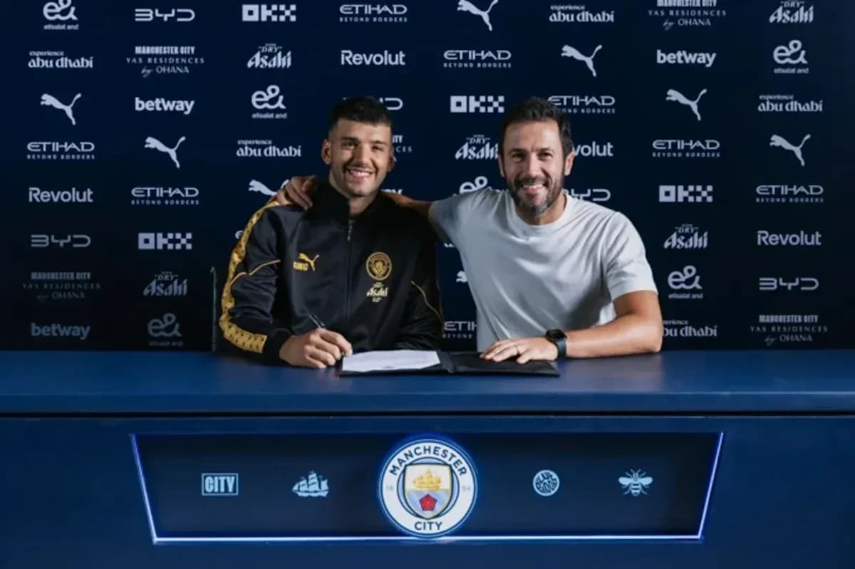 Jugador y entrenador posando tras firma de contrato