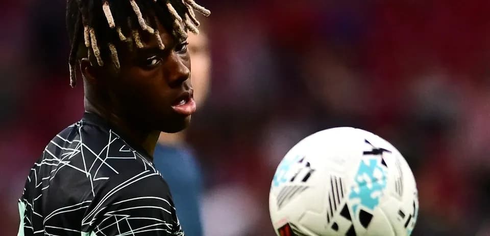 Jugador mirando hacia la cámara con balón en movimiento