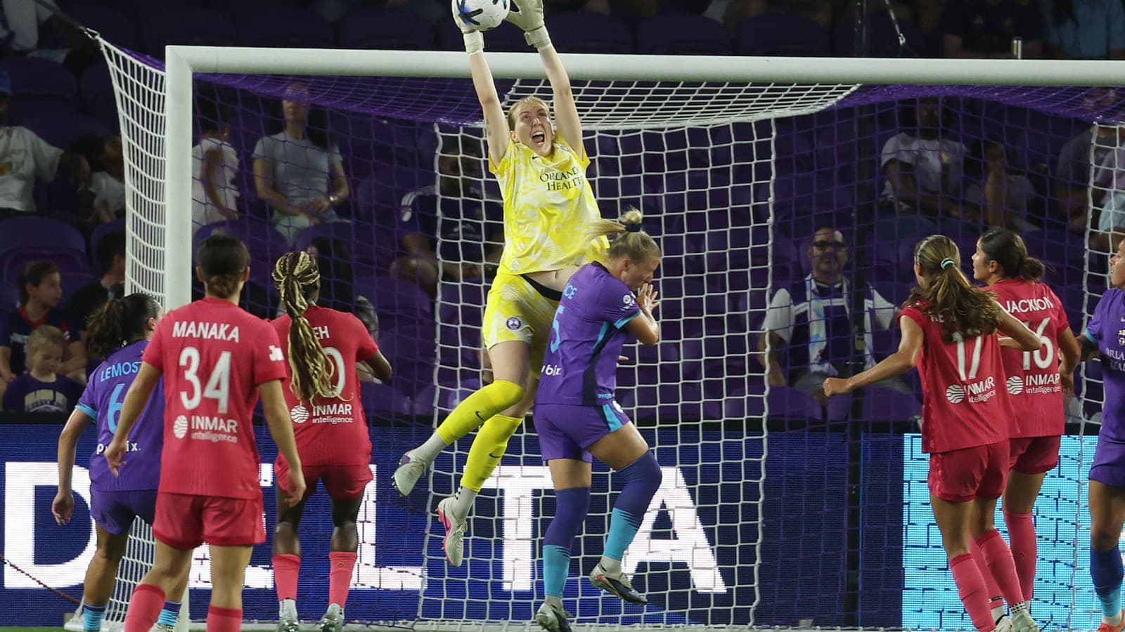 Portera atrapando el balón en el partido