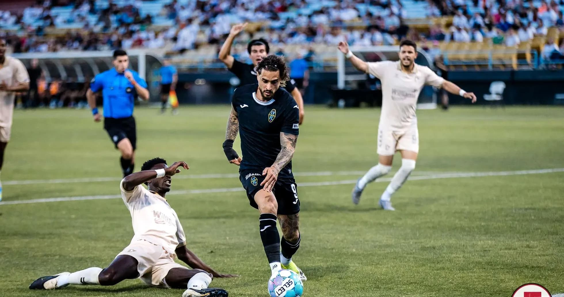Un jugador driblando durante el partido de fútbol Un jugador driblando durante el partido de fútbol