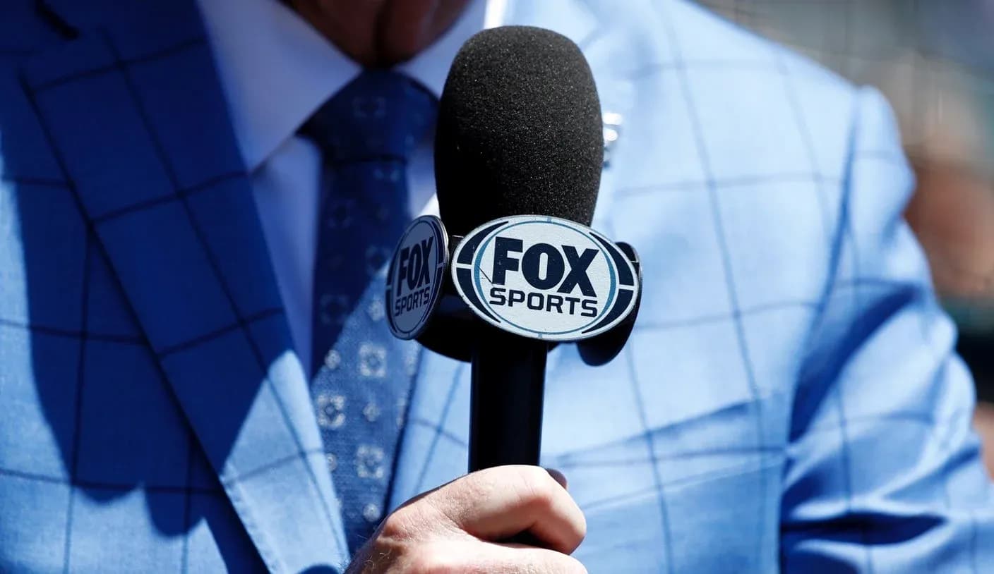 Mic with FOX Sports logo held by a person Mic with FOX Sports logo held by a person