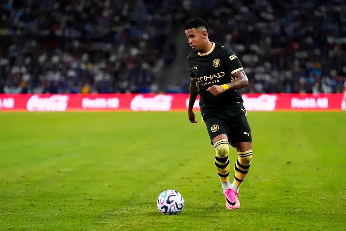 Jugador de fútbol corriendo con balón en el campo Jugador de fútbol corriendo con balón en el campo