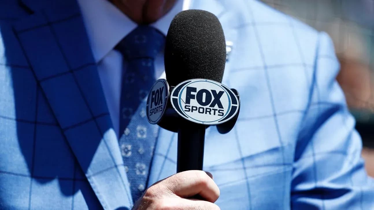 Mic with FOX Sports logo held by person Mic with FOX Sports logo held by person