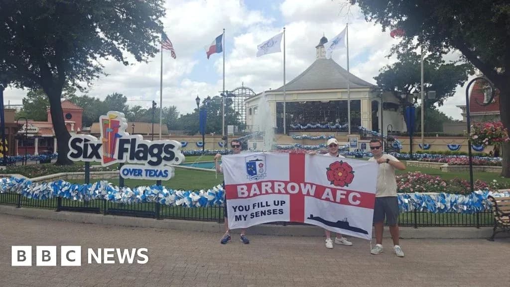Dos aficionados sosteniendo una bandera de Barrow AFC Dos aficionados sosteniendo una bandera de Barrow AFC