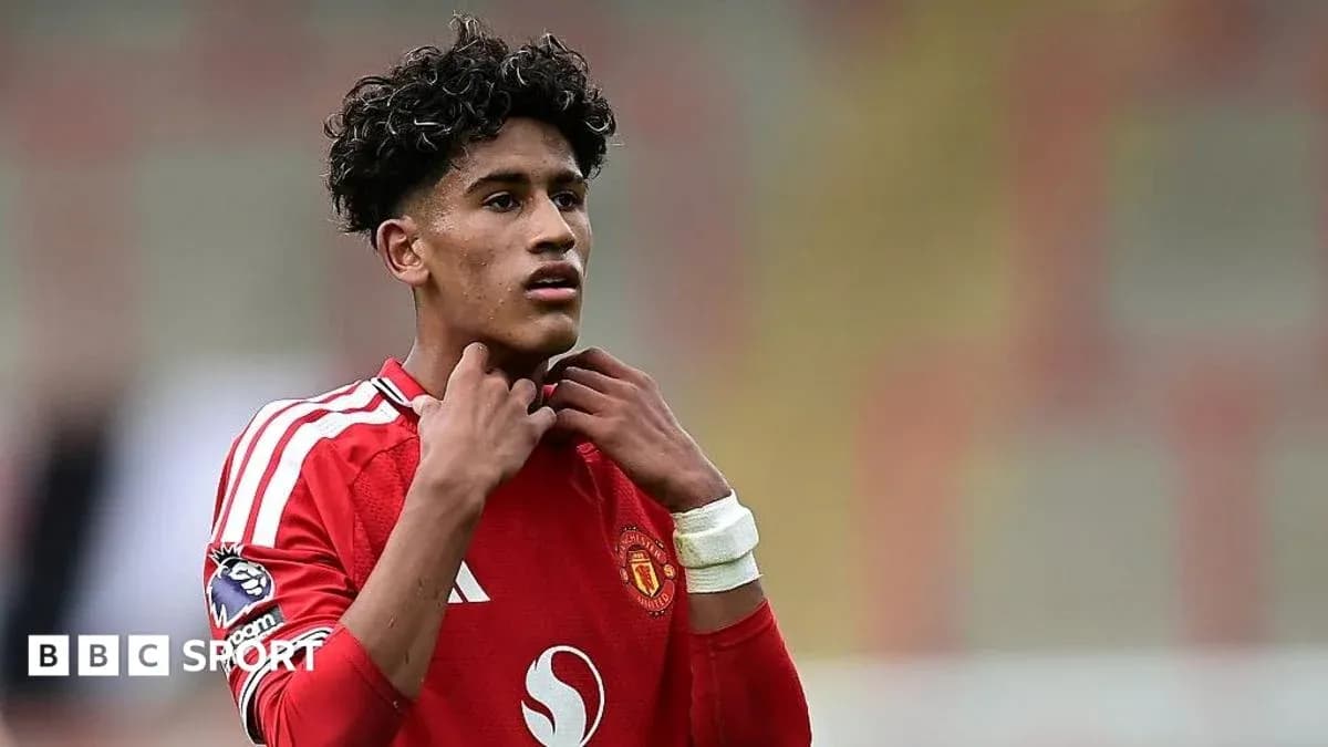 Jugador de Manchester United ajustando su camiseta en el campo Jugador de Manchester United ajustando su camiseta en el campo
